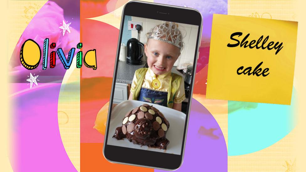 A girl shows a chocolate cake in the shape of Blue Peter's Shelley the tortoise that she has baked.