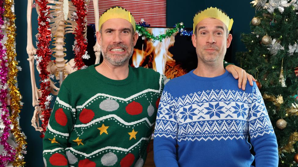 Chris and Xand pose in Christmas jumpers