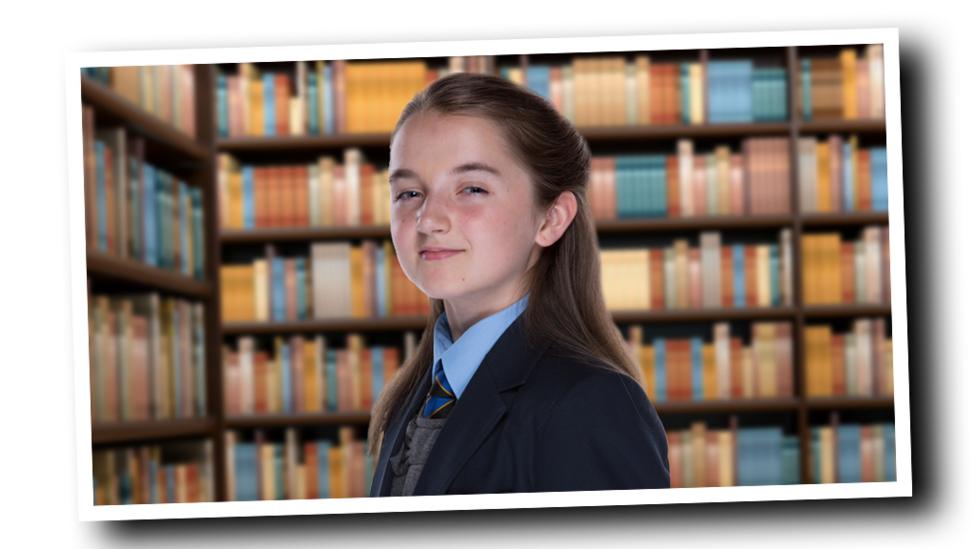 Cassie standing in a library.