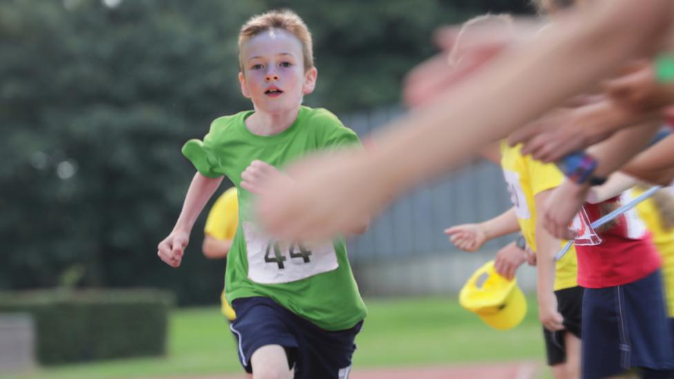 Boy running a race in school Sports Day.