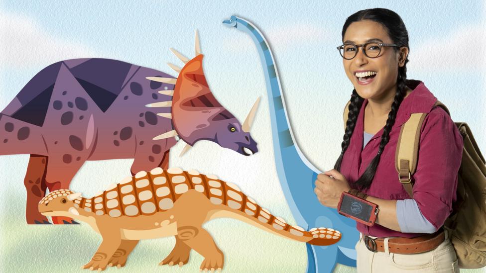 Jen from Andy's Dino Island poses next to cartoon dinosaurs.