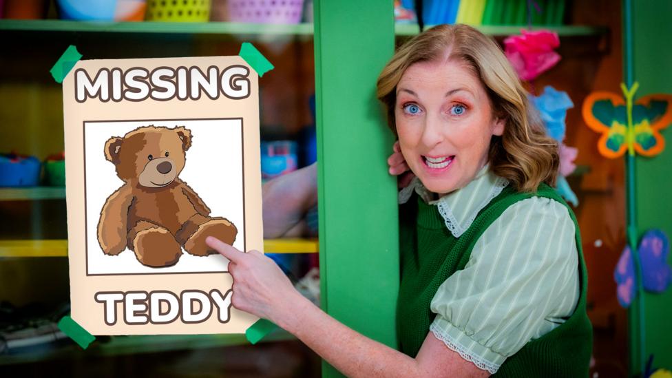 Miss Hoolie in the Balamory Nursery, pointing to a poster showing a Missing Teddy.