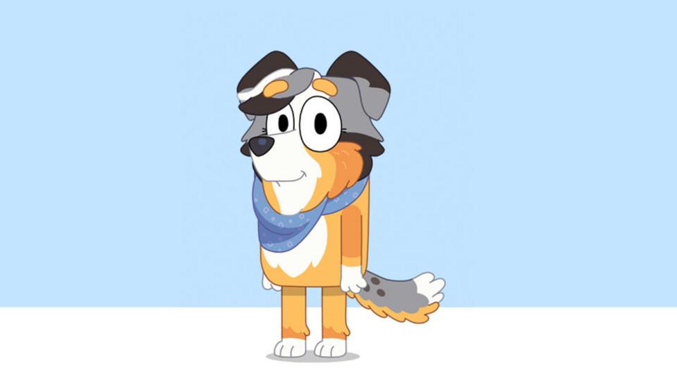 A grey and tan cartoon Australian Shepherd dog wearing a neckerchief.