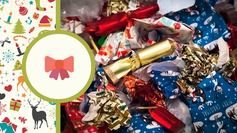 Lots of used wrapping paper and Christmas crackers all scrunched up on the floor