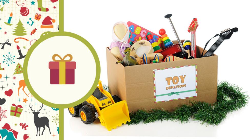 Lots of toys in a cardboard box that has the label'Toy donations' on it