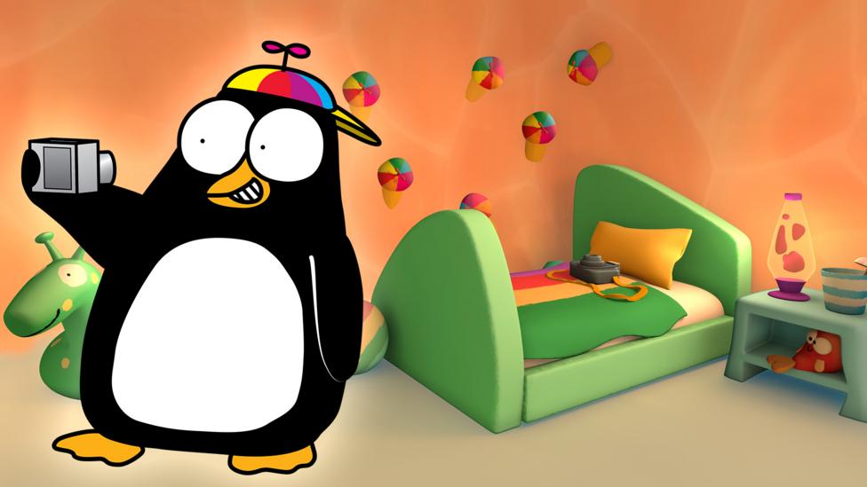 A cartoon penguin wearing a rainbow propeller hat takes his own picture with a camera, his bedroom is behind him with a wall of propeller hats and a lava lamp.