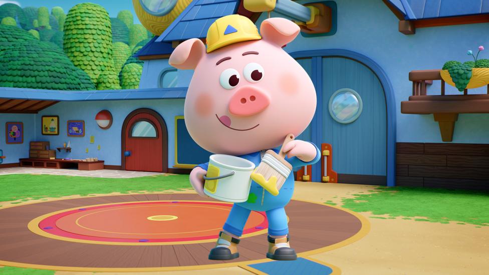 Image of Charlie from Piggy builders holding a paint brush and bucket