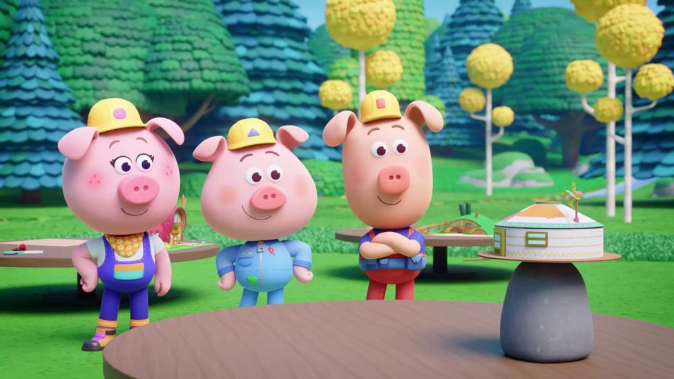 Image of three Piggy Builders looking at a model