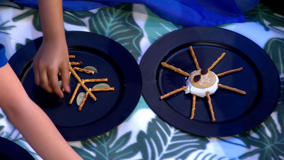 A plate holding crackers with straight pretzel legs.