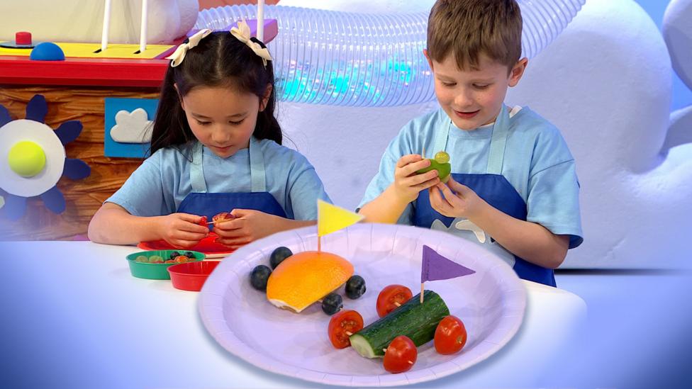 Children making racing cars out of fruit and vegetables.