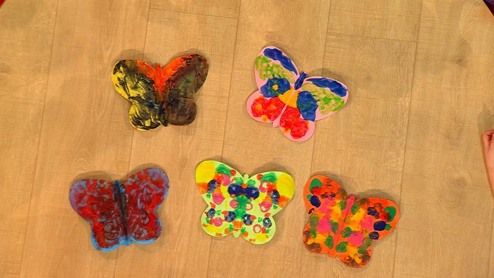 Five colourful butterfly cutouts.