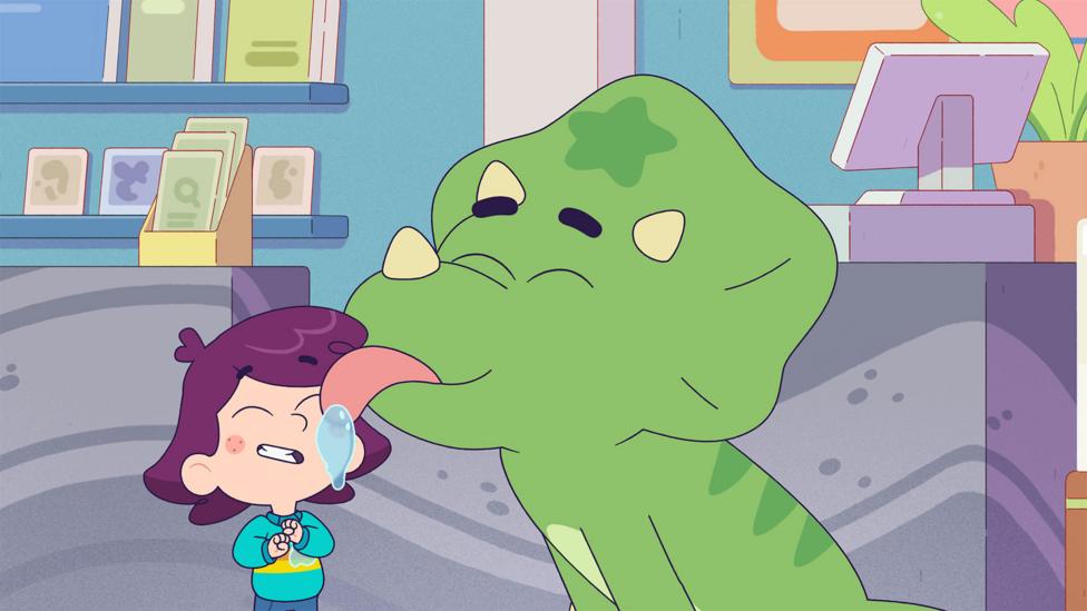 Rafi, a cartoon seven-year-old girl, grins as Slurpy, a small green dinosaur, licks her face.