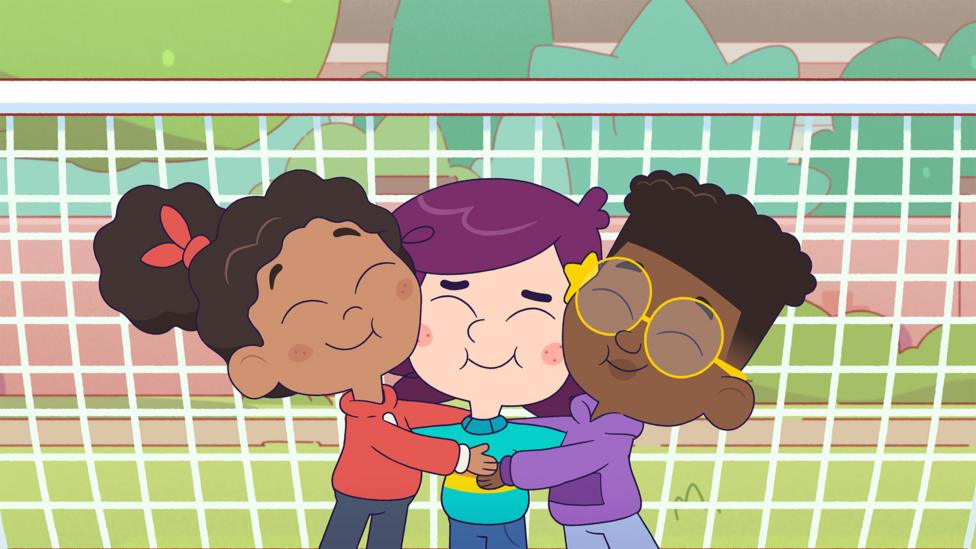 Image of characters from Rafi having a group hug in front of a football goal.