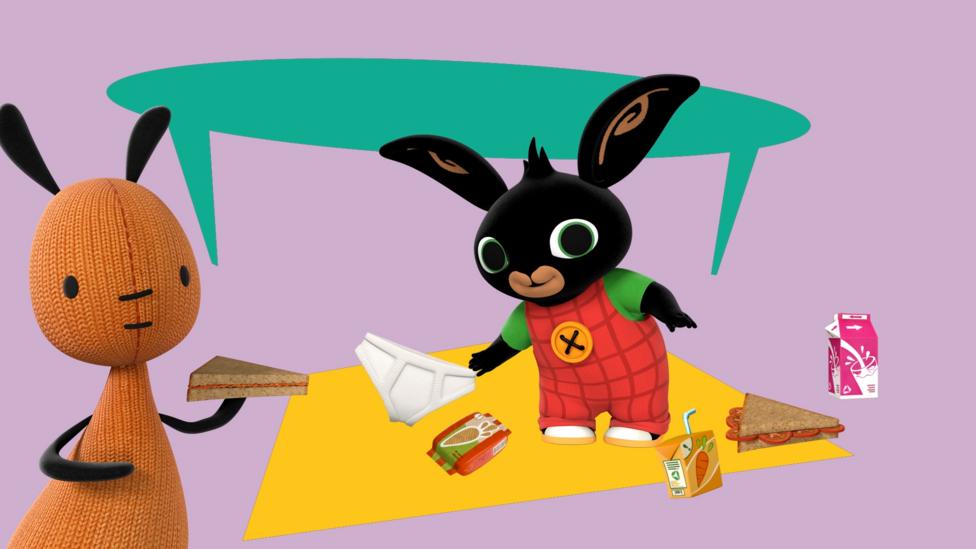 Bing and Flop, a young black bunny and a knitted floppy toy, eating a picnic in their kitchen.