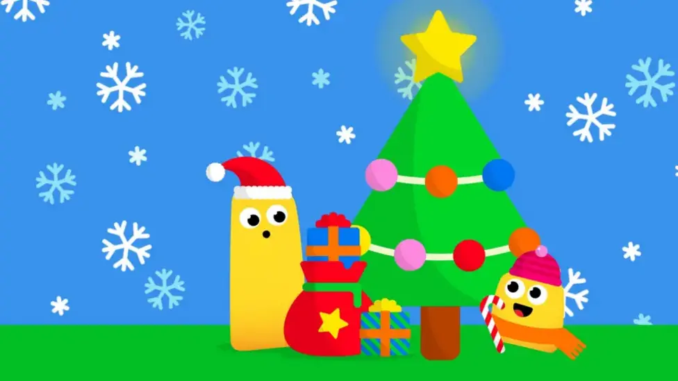 Two yellow CBeebies bugs wearing santa hats and scarves decorate a colourful Christmas tree in the snow.