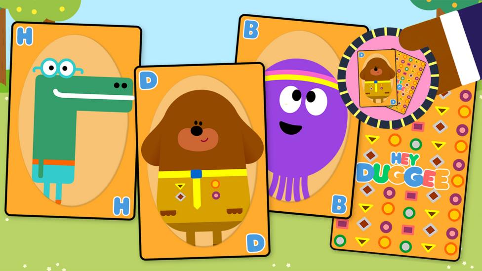 Cards with duggee and betty on. There is a hand with a snap badge.
