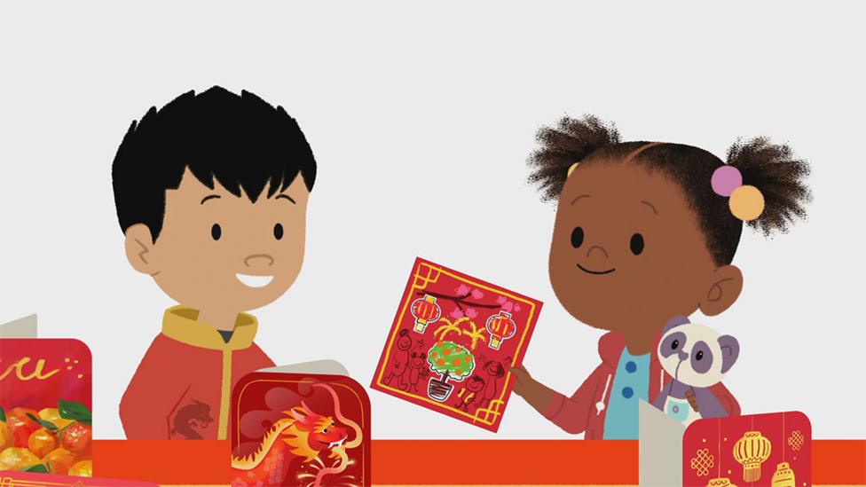 JoJo giving Henry a Lunar New Year card.