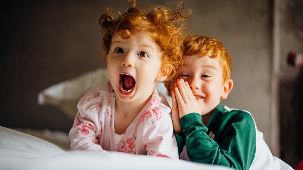 Sister and brother laughing together.