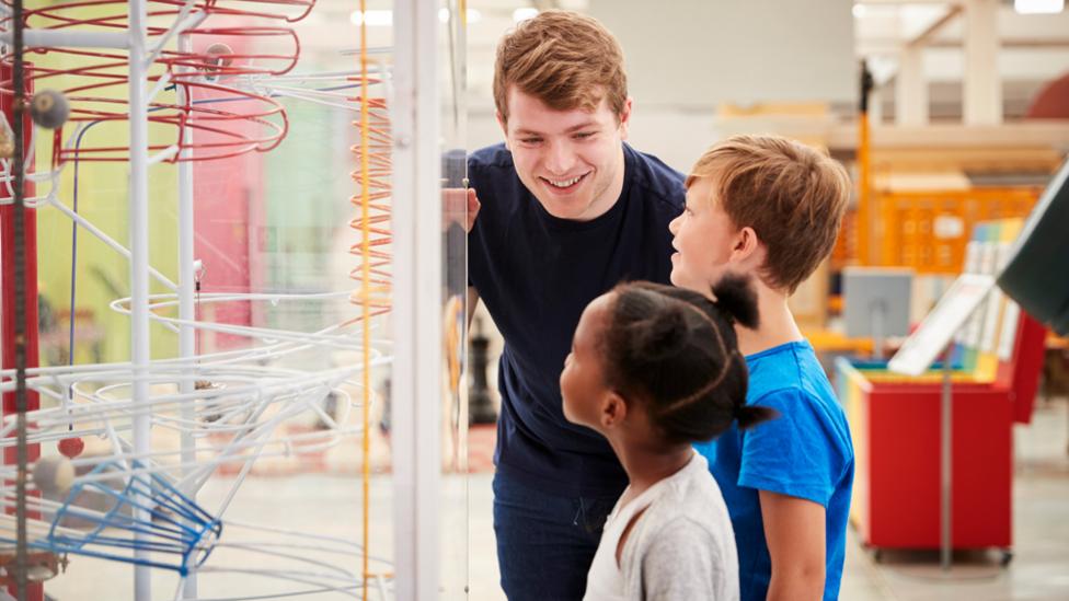 Children in UK museum with guide.