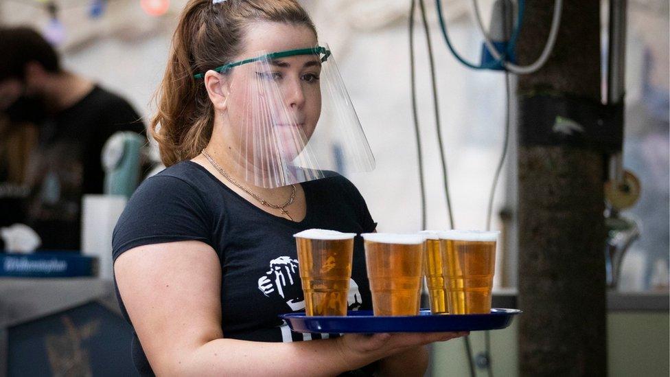 bar worker carrying beer