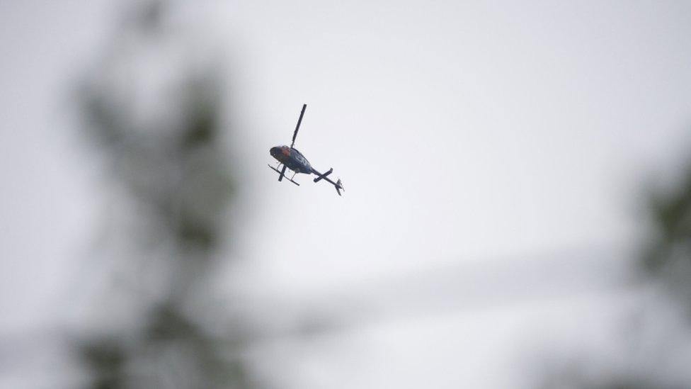 News helicopters hover of the courthouse