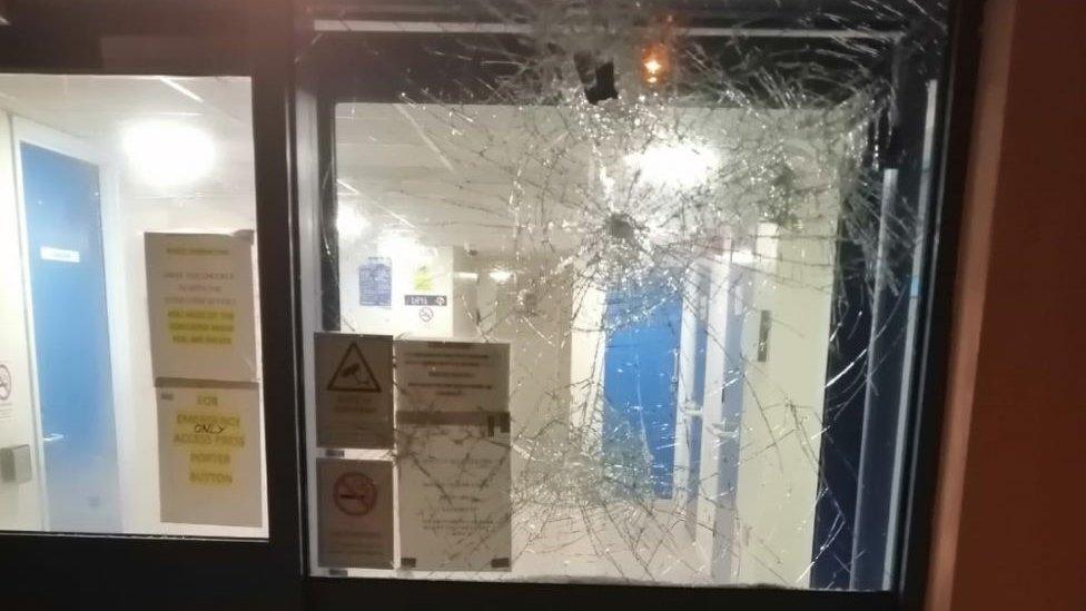 a smashed window in an office door