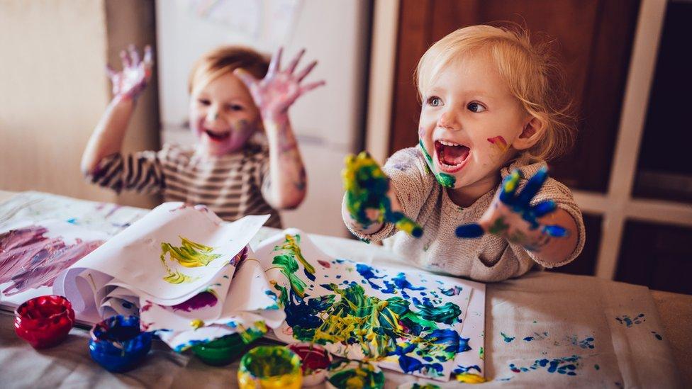 Children painting on kitchen table