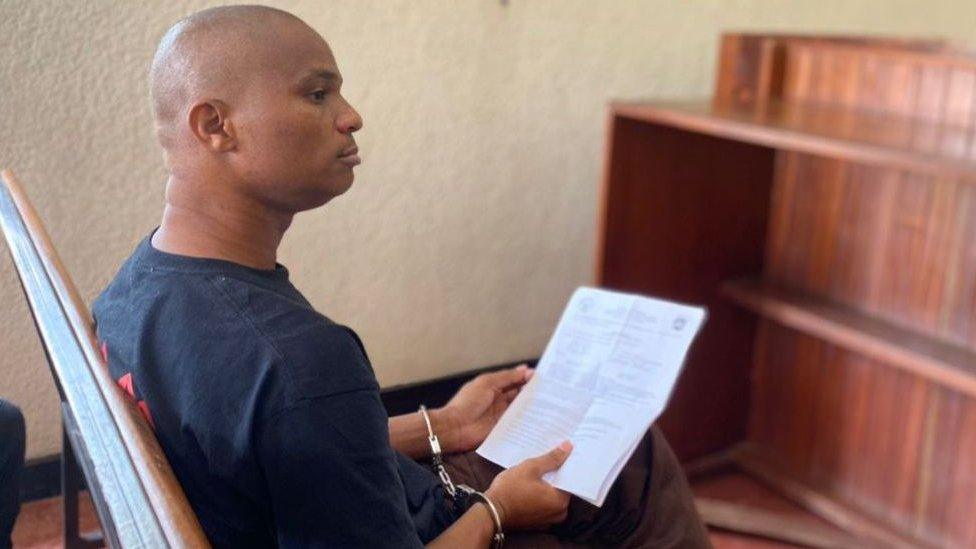 Denis Kazungu, 34, an alleged serial killer accused of killing more than 10 people in Rwanda, appears in a court on 21 September, 2023.