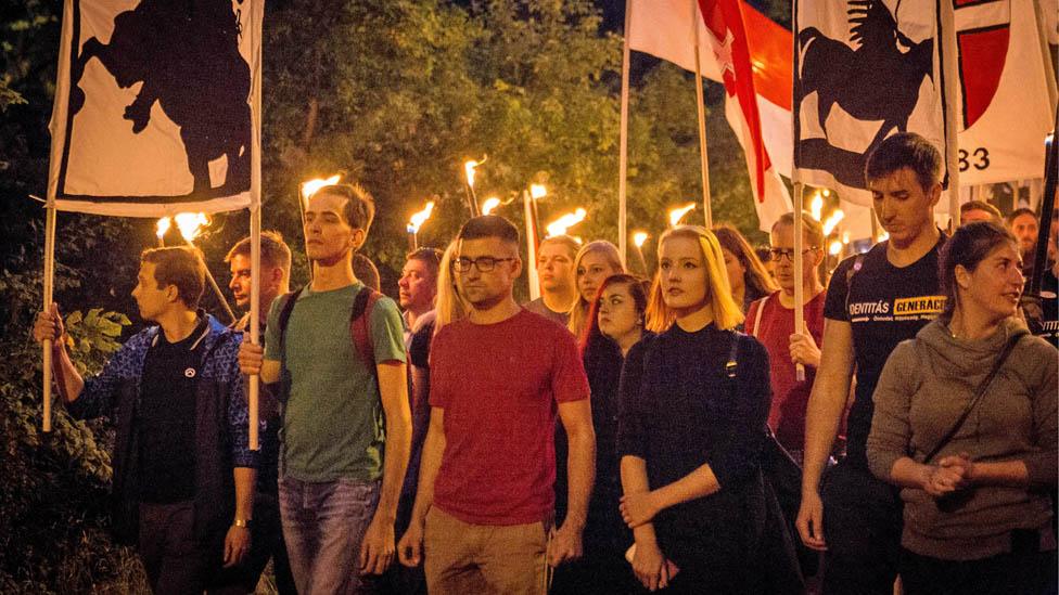 Martin Sellner (centre) on a torch-lit march near Vienna in September 2017