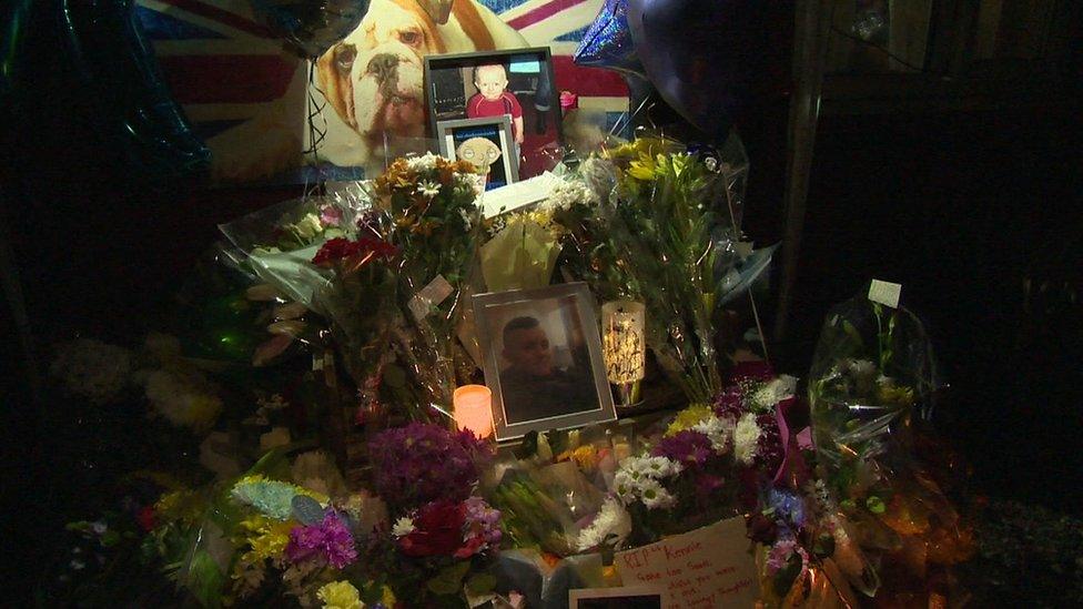 Floral and photographic tributes to boy stabbed to death