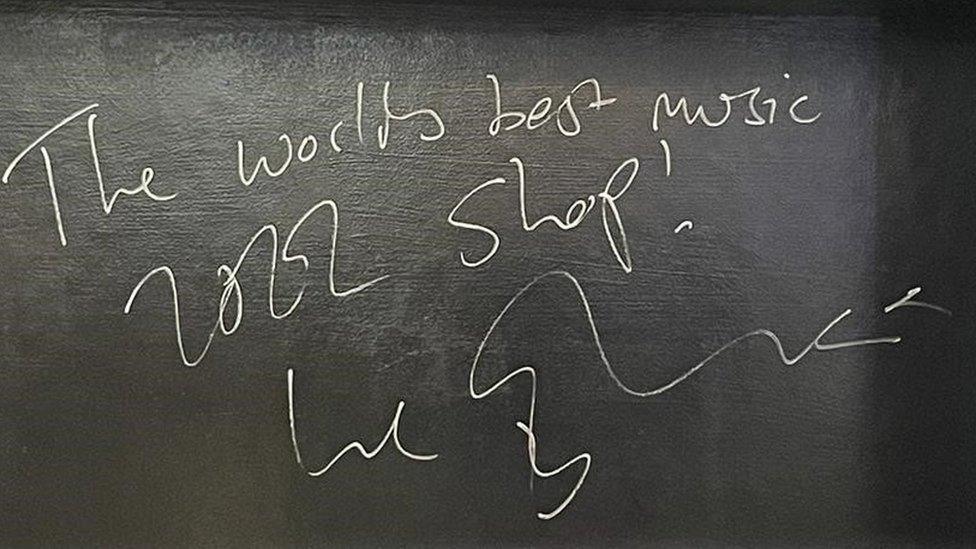 Wall in music shop signed by Sheeran