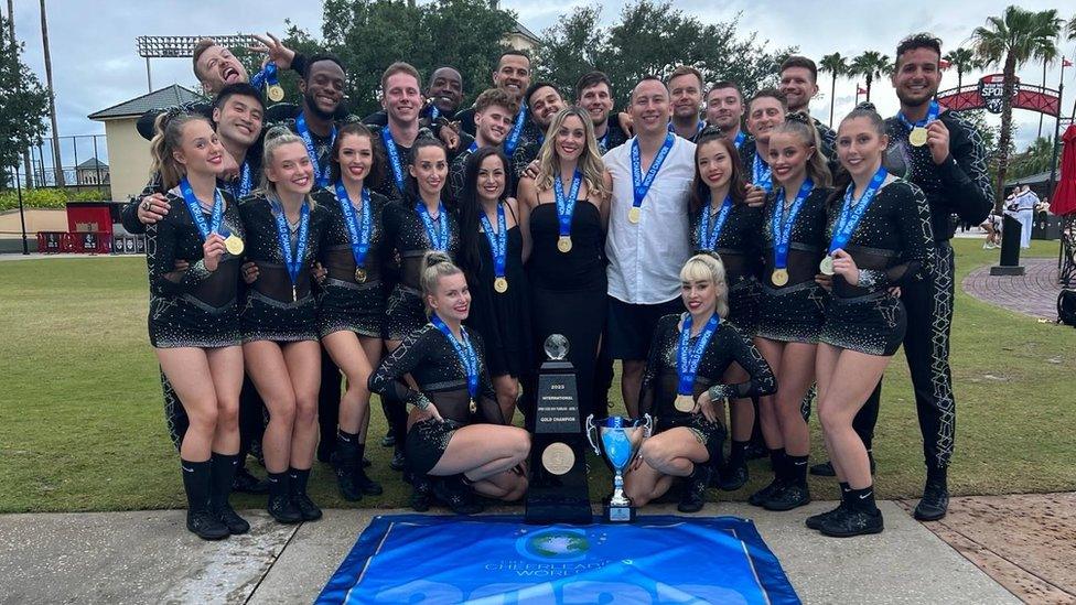 Unity Allstars Black posing with medals and a trophy