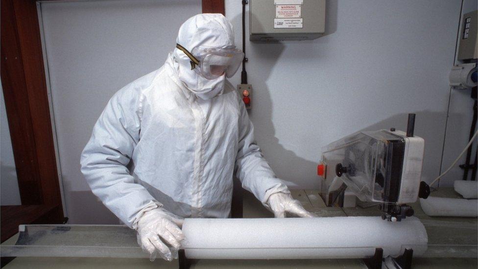 A scientist examines an ice core drilled in the Antarctic