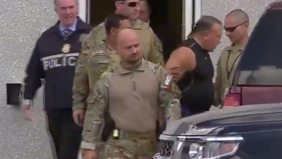 Cesar Sayoc (2nd right) is escorted by FBI agency