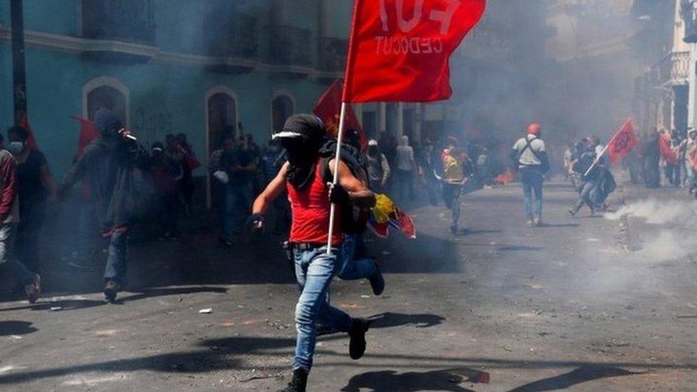 Protester running through the streets waving a red flag