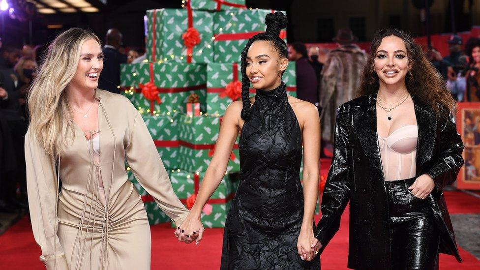 little mix holding hands at a red carpet event