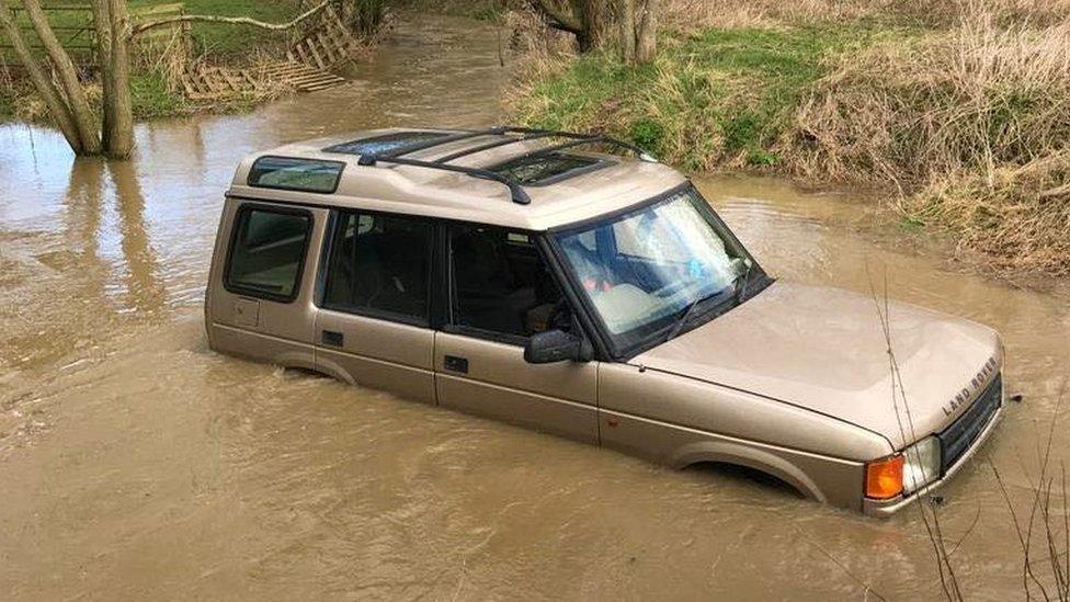 car stuck in floodwater