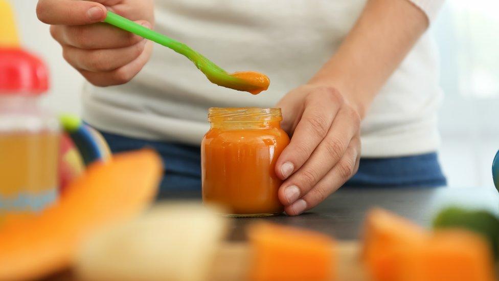 Woman preparing baby food