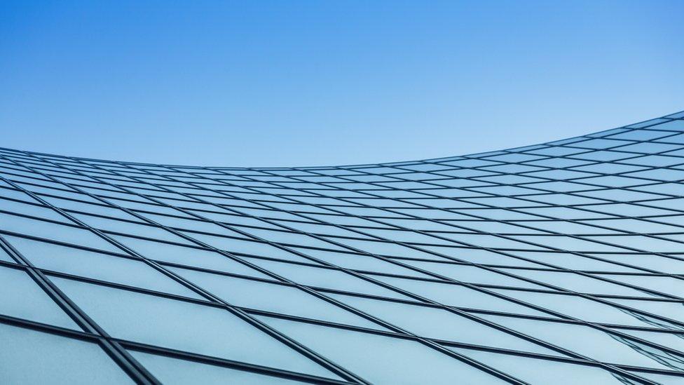 glass building reflecting the sky