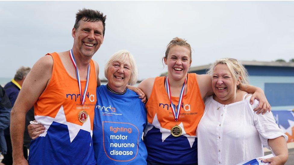 Stuart Bates, his mother Mary Bates, Charlotte Nichols and her mother Sally Nichols after Stuart and Charlotte finished their marathon.