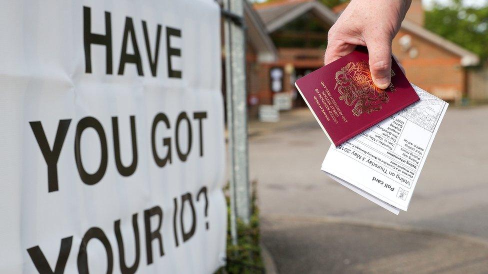 File photo of a voter carrying his passport along with his polling card