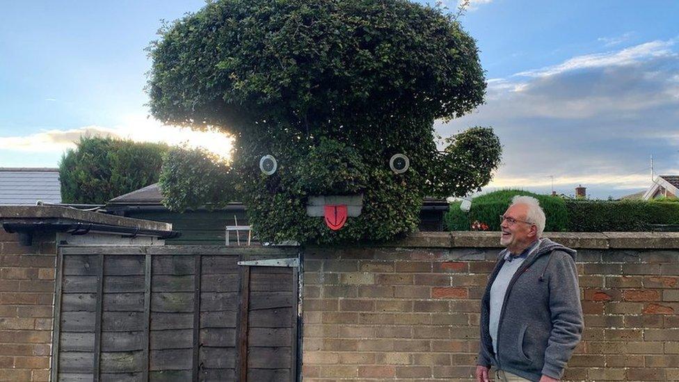 Mike Bone smiling at the tree