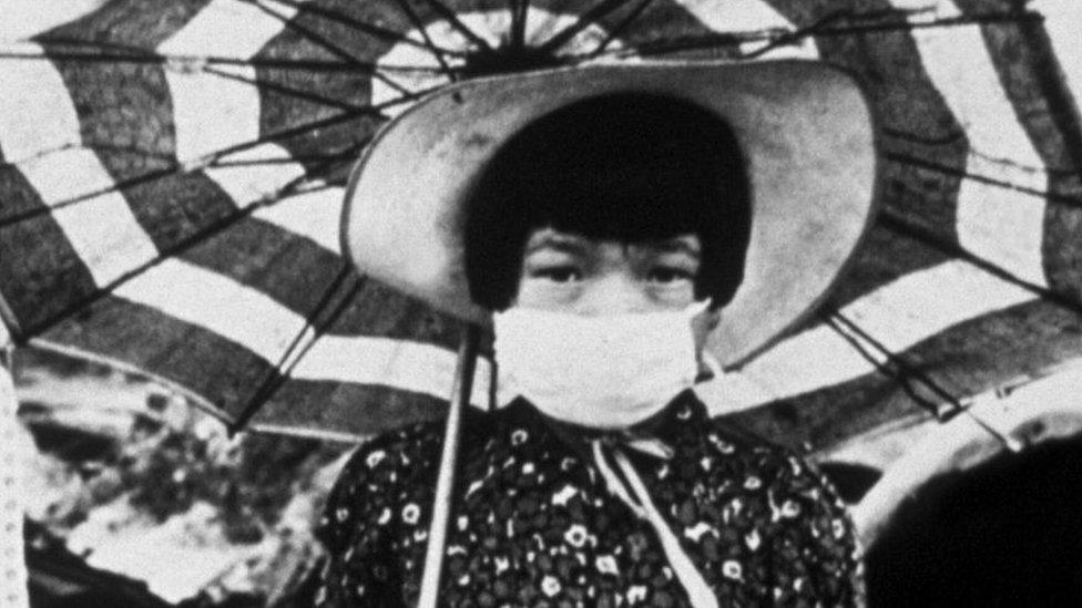 Children in Hiroshima, Japan, wearing masks to combat the odour of death after the city was destroyed by the first atom bomb, October 1945.