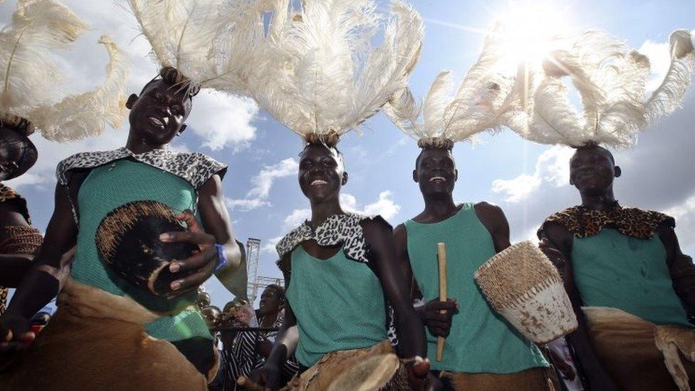 People wearing traditional clothes dance prior to the arrival of Pope Francis for a meeting with young people at the Kololo airstrip in Kampala, Uganda, Saturday 28 November 2015