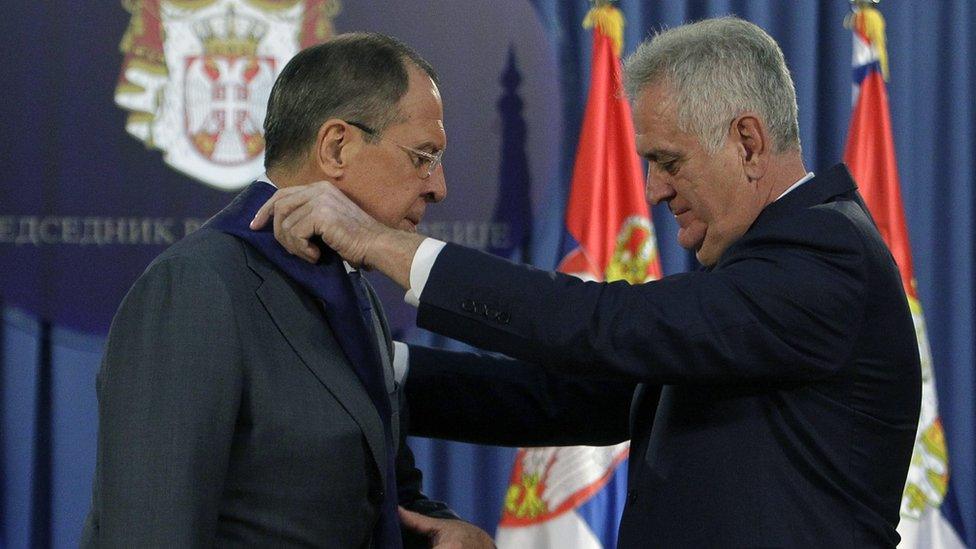 Russian foreign minister Sergei Lavrov (L) receives a medal from Serbian President Tomislav Nikolic (12 Dec)