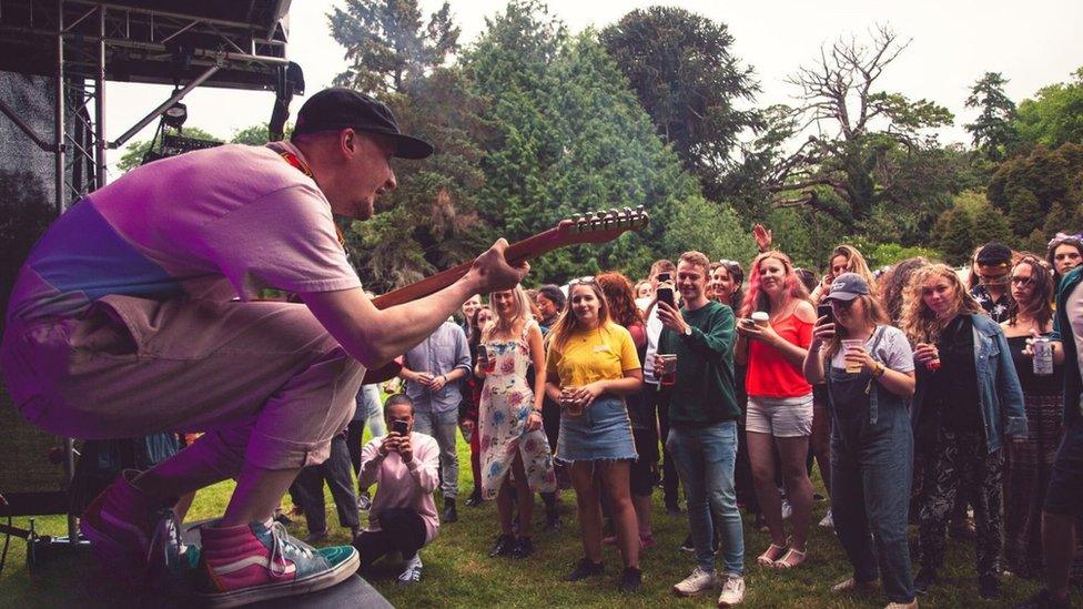 Musician playing in front of a crowd