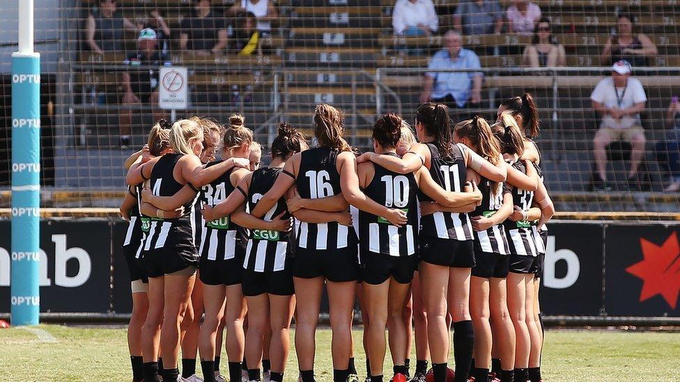 players stand for a minutes silence in tribute to the Christchurch Mosque terror attack during the AFLW Rd 7 match between Collingwood and Brisbane at Victoria Park