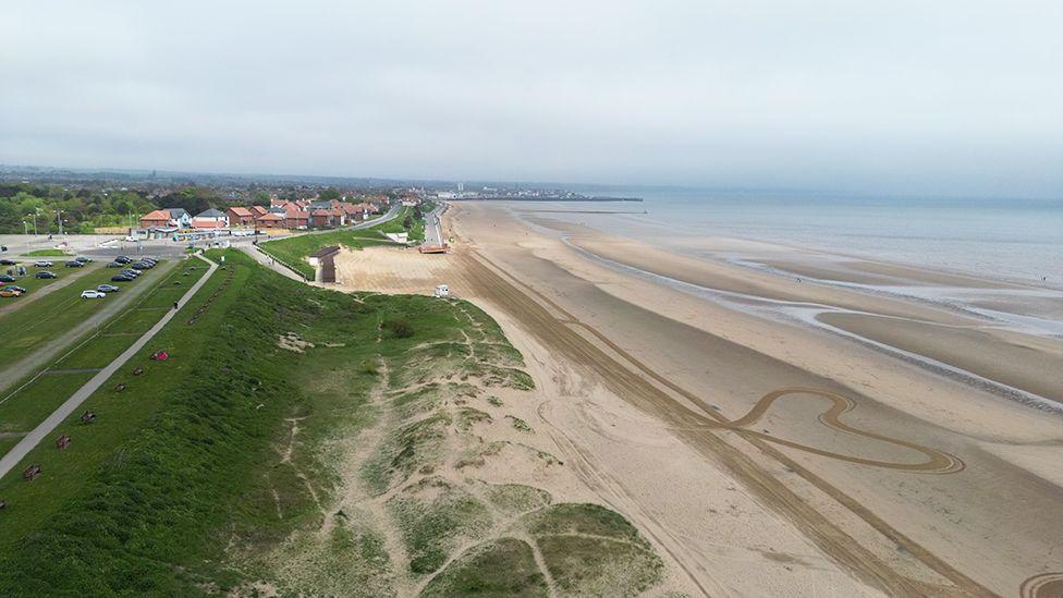 Aerial view of Bridlington South Beach with the tide out and houses in the foreground