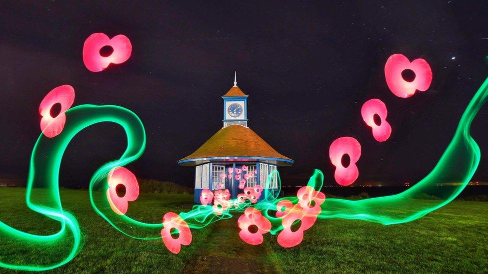 Clock tower at Frinton-on-Sea photographed at night with lighting techniques to add poppies and light trails