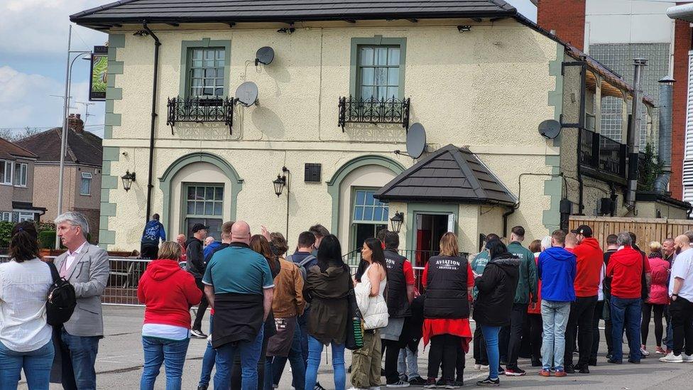 Queue outside the Turf pub, Wrexham